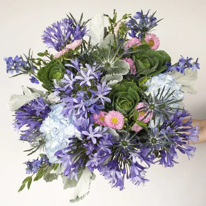 Clear Blue Skies Flower Arrangement in Hand