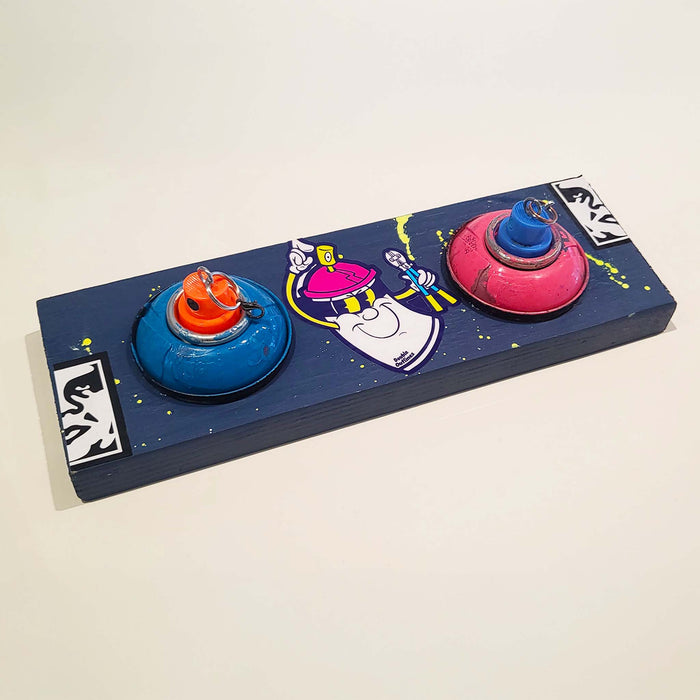 Blue mounted keychain holder with spray paint tops and nozzles.