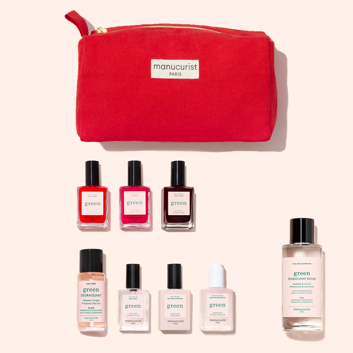 The Manucurist Starter Kit includes a red pouch, seven plant-based nail polishes, and four essential liquid bottles—everything for a Green manicure—arranged neatly on a light background.