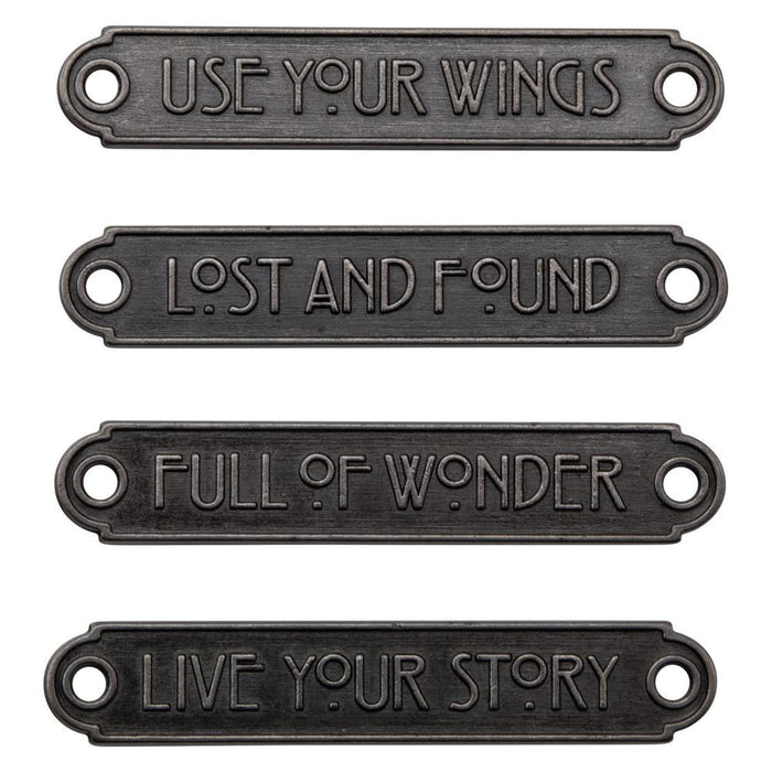 Tim Holtz - Idea-Ology - Metal Word Plaques - 4/Pkg. Tim Holtz Word Plaques are metal labels that feature unique raised words on each. Simply adhere or use Tim Holtz fasteners for an expressive label on your next make. Word Plaques by Tim Holtz are decorative metal labels with raised words. Available at Embellish Away located in Bowmanville Ontario Canada.