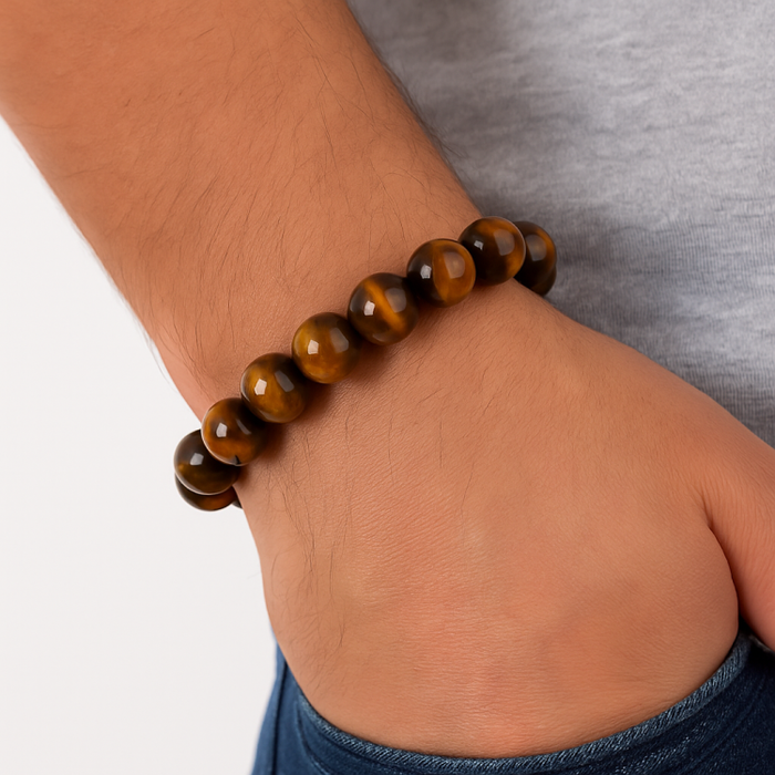 12mm brown tiger eye and silver bead bracelet worn on wrist.