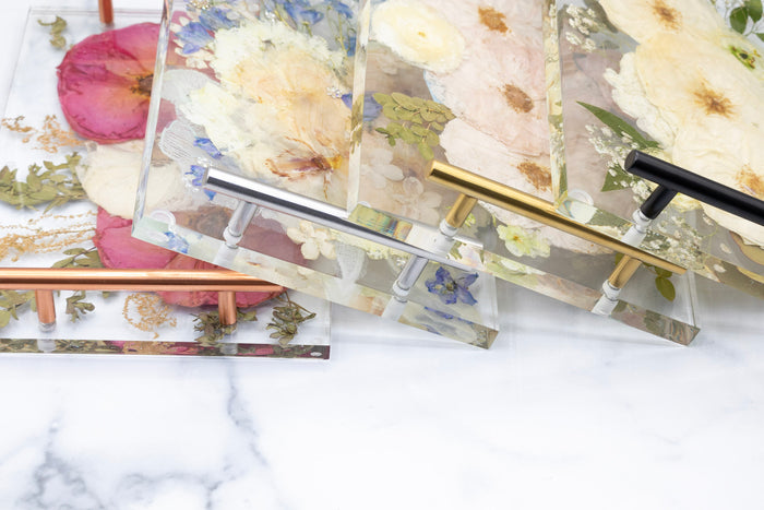 12x8 Tray & Round Coaster Bundle featuring floral designs in resin with elegant metallic handles on a marble surface.