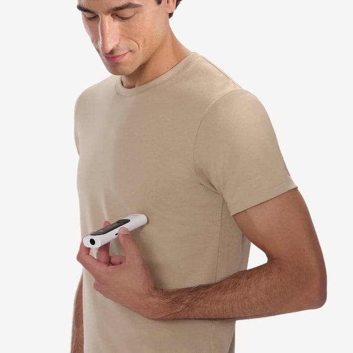 Withings BeamO — Beam-O — Man in beige t-shirt holding the white BeamO device in hand, three-quarter view, plain white background — casual wear, handheld, neutral background