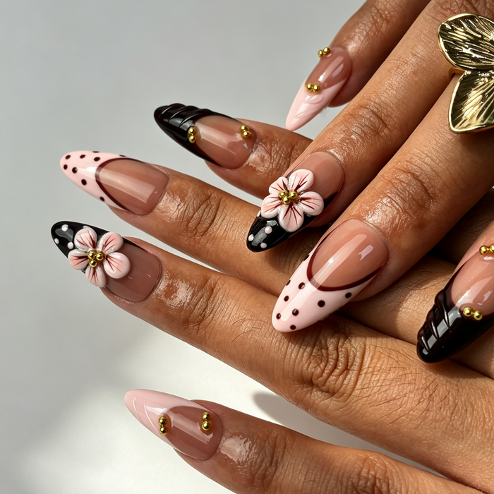 Close‑up handmade press‑on nails, wine spotted print pink sculpted flower manicure