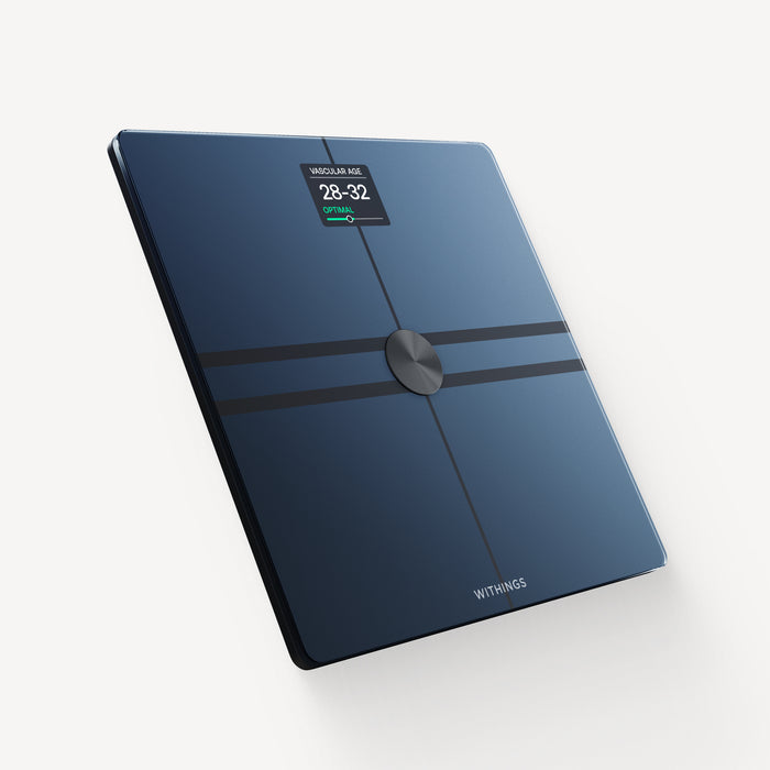 Withings Body Comp — Black — Three-quarter view on neutral background, screen displaying vascular age 28-32 optimal — three-quarter, black, light background, lit screen