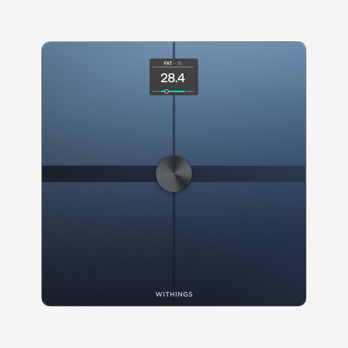 Body Smart — Black — Top-down view on neutral background, screen displaying 28.4% body fat, dark blue surface, metallic center — top-down, black, active screen