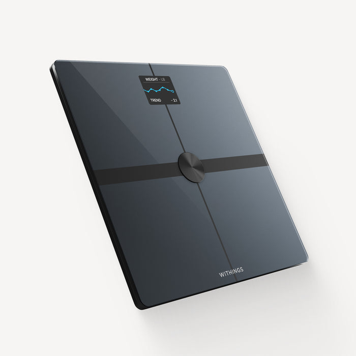 Withings Body Smart — Black — Three-quarter view on white background, screen displaying weight trend in pounds, sleek black glass design — three-quarter, plain background, screen on, black