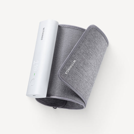 Withings BPM Connect — Connected blood pressure monitor — Top-down view, rolled grey cuff with white monitor module, plain light background — top-down, cuff, white module, compact