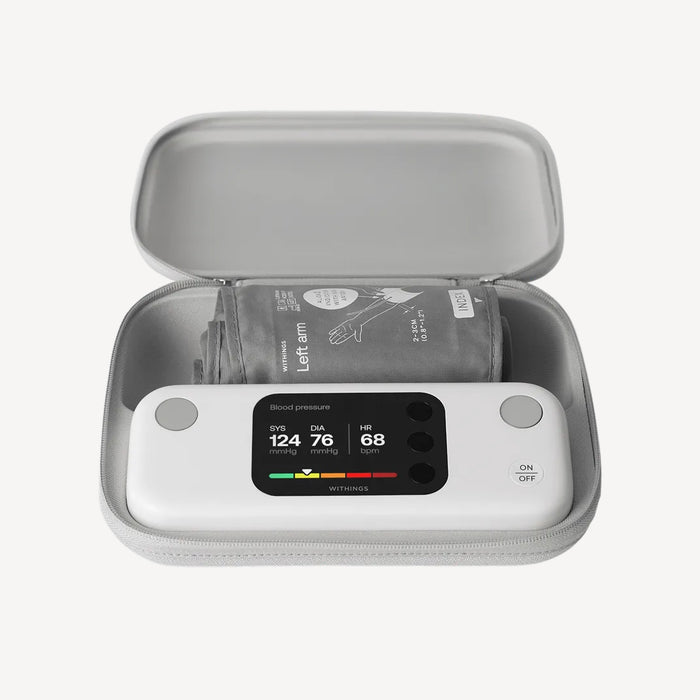BPM Vision — Connected Blood Pressure Monitor — Top-down view in open grey travel case, screen showing SYS 124 DIA 76 HR 68, cuff folded inside — travel case, lit display, top-down, open case