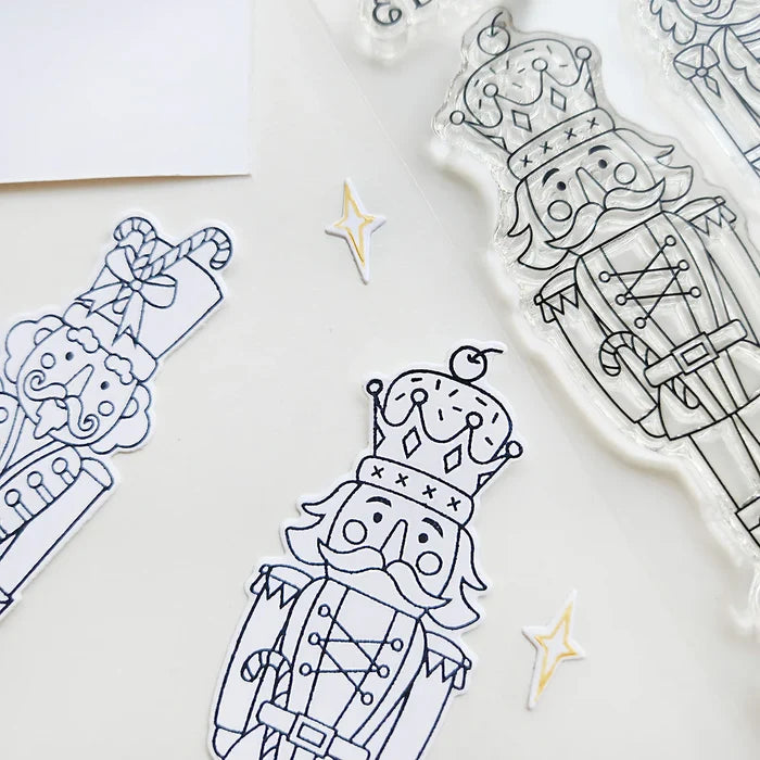 Catherine Pooler - Stamp &amp; Die Set - Nutcracker Sweet. Meet the cutest nutcrackers in town! This whimsical set features charming nutcrackers adorned in a delightful array of sweets and treats, including cupcakes, candy canes, and figgy pudding. Available at Embellish Away located in Bowmanville Ontario Canada.