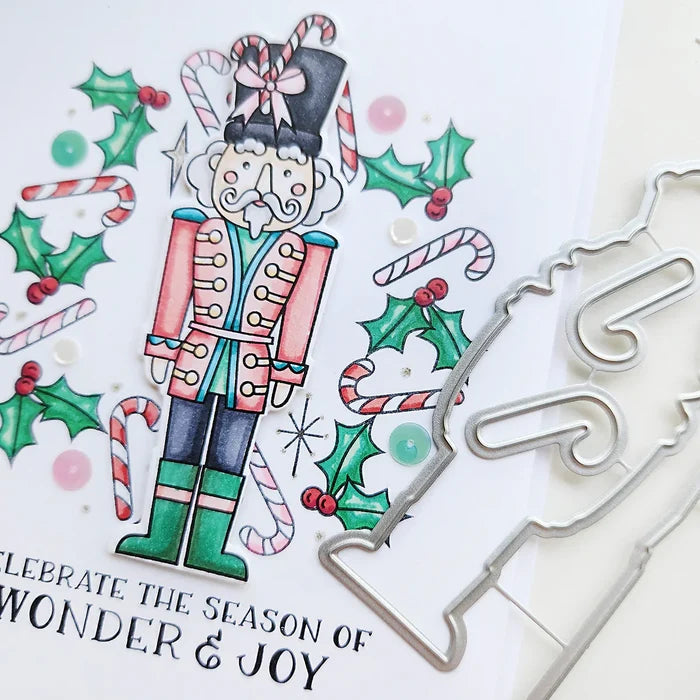 Catherine Pooler - Stamp &amp; Die Set - Nutcracker Sweet. Meet the cutest nutcrackers in town! This whimsical set features charming nutcrackers adorned in a delightful array of sweets and treats, including cupcakes, candy canes, and figgy pudding. Available at Embellish Away located in Bowmanville Ontario Canada.