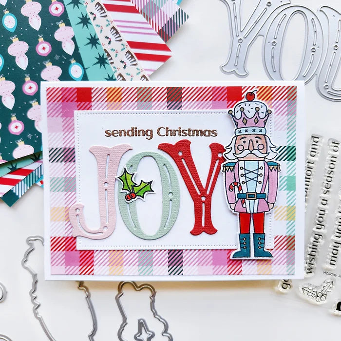 Catherine Pooler - Stamp &amp; Die Set - Nutcracker Sweet. Meet the cutest nutcrackers in town! This whimsical set features charming nutcrackers adorned in a delightful array of sweets and treats, including cupcakes, candy canes, and figgy pudding. Available at Embellish Away located in Bowmanville Ontario Canada. Example by Catherine Pooler Designs.