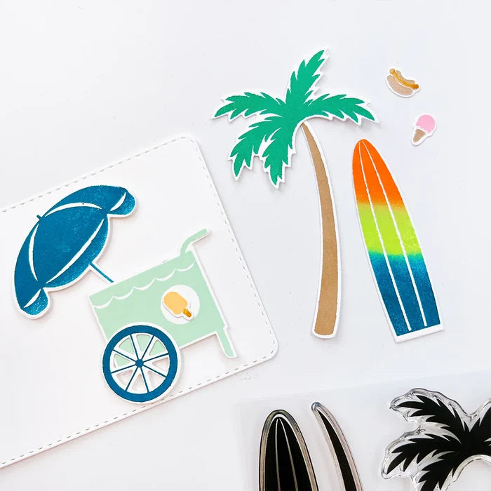 Catherine Pooler - Stamp &amp; Die Set - On the Boardwalk. This set is perfect for building scenes, clustering or simple cards. This set includes a palm tree, surf board, the boardwalk fence and all the bits to build your own treat cart. Available at Embellish Away located in Bowmanville Ontario Canada.