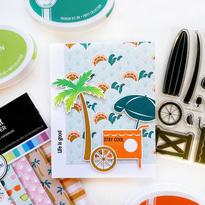 Catherine Pooler - Stamp &amp; Die Set - On the Boardwalk. This set is perfect for building scenes, clustering or simple cards. This set includes a palm tree, surf board, the boardwalk fence and all the bits to build your own treat cart. Available at Embellish Away located in Bowmanville Ontario Canada. Example by Catherine Pooler Designs.