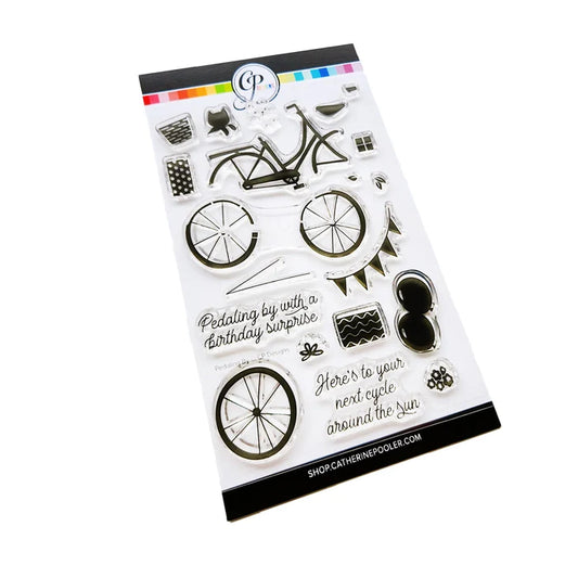 Catherine Pooler - Stamp &amp; Die Set - Pedaling By. Featuring a birthday bike with tons of fun decorations. Decorate with the gifts, balloons and bunting. There's also a basket that can be filled with flowers or a kitty to take along or the ride! Available at Embellish Away located in Bowmanville Ontario Canada.