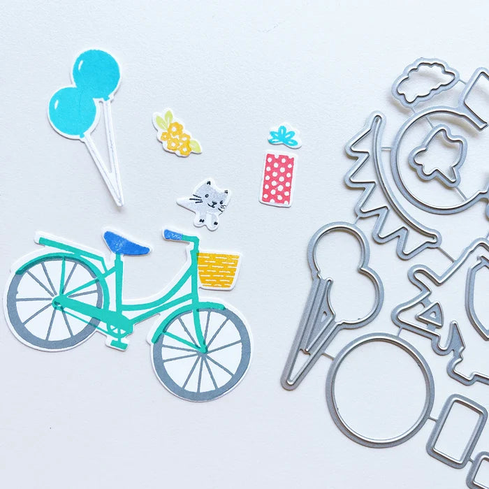 Catherine Pooler - Stamp &amp; Die Set - Pedaling By. Featuring a birthday bike with tons of fun decorations. Decorate with the gifts, balloons and bunting. There's also a basket that can be filled with flowers or a kitty to take along or the ride! Available at Embellish Away located in Bowmanville Ontario Canada.