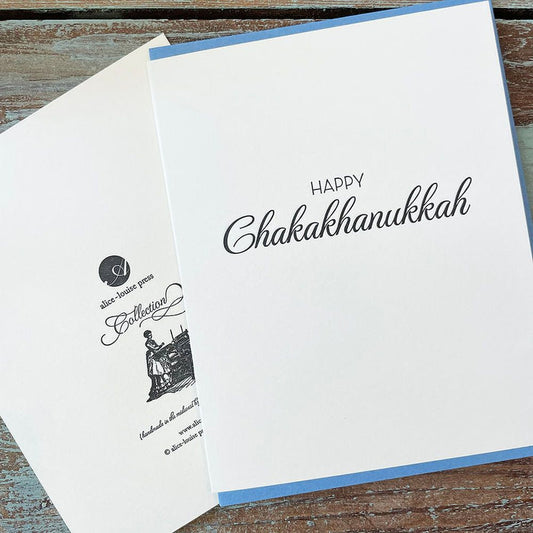 White greeting card with 'HAPPY' and 'ChakaKhanukkah' script text on front