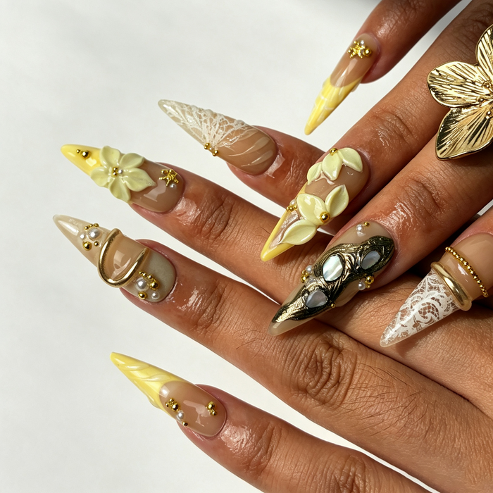 Close‑up handmade press‑on nails, ivory sculpted flower wave texture tiny rhinestone manicure