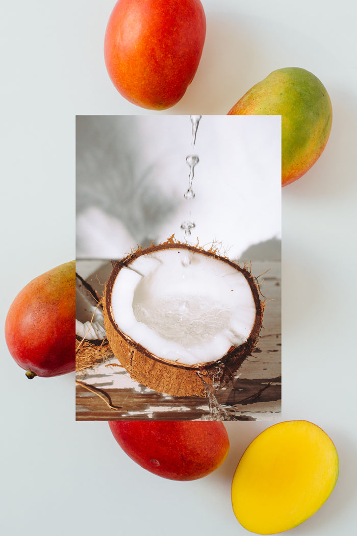 mango slices on background with open coconut in front