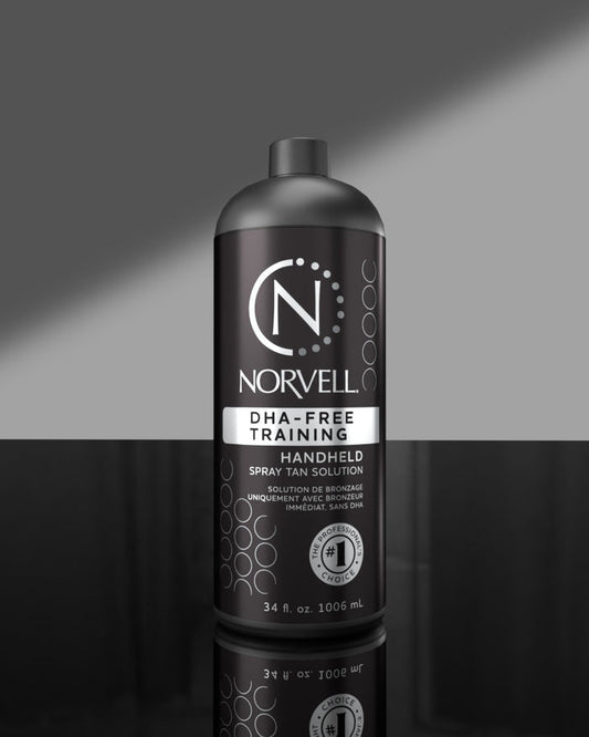 Norvell handheld DHA Free spray tan solution bottle on a gray background