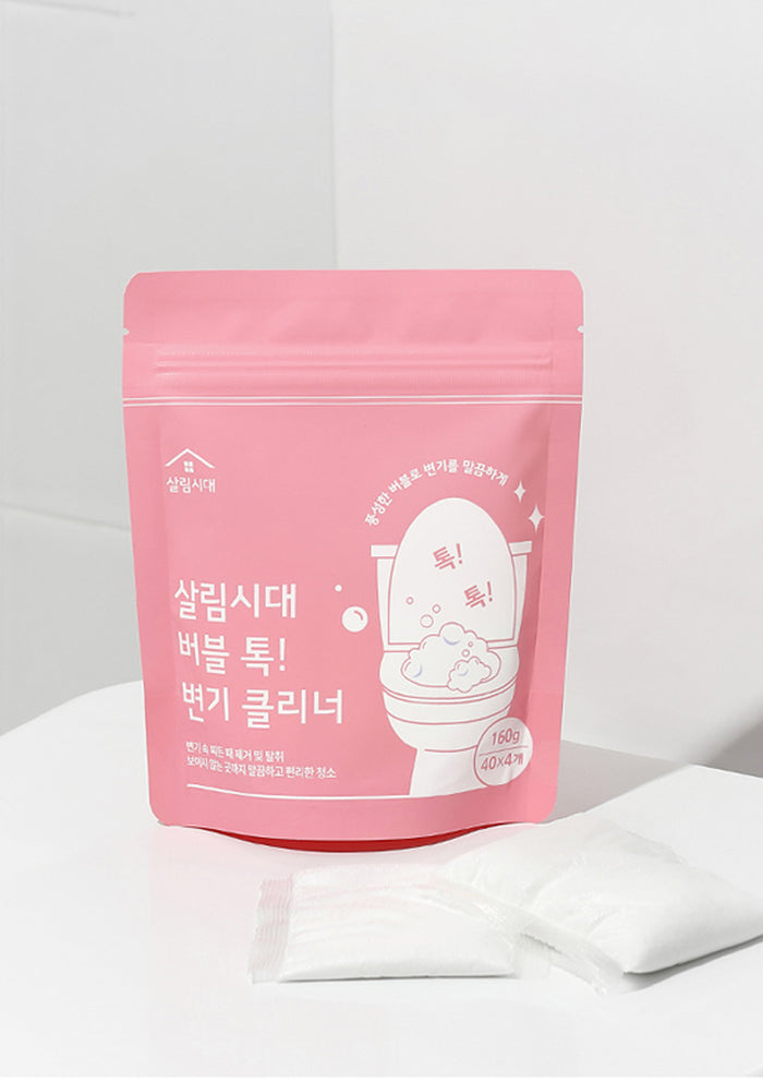 Pink packaging of a toilet cleaning product with Korean text on a white background