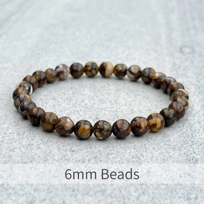 Fire Lace Opal beaded bracelet with 6mm natural beads on gray background.