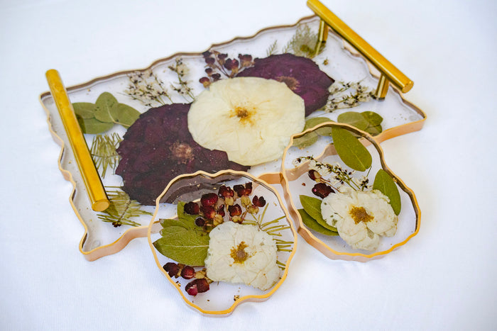 Decorative tray with floral and fruit designs on a white background