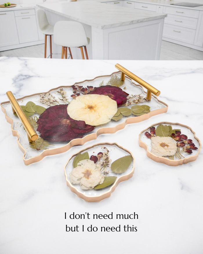 Portrait photo of a pressed flower acrylic tray with soft dried roses on a kitchen counter