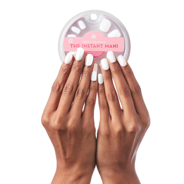 Hands with HD - Press-On | Short | Squoval nails in clean white holding packaged short squoval press-on false nails