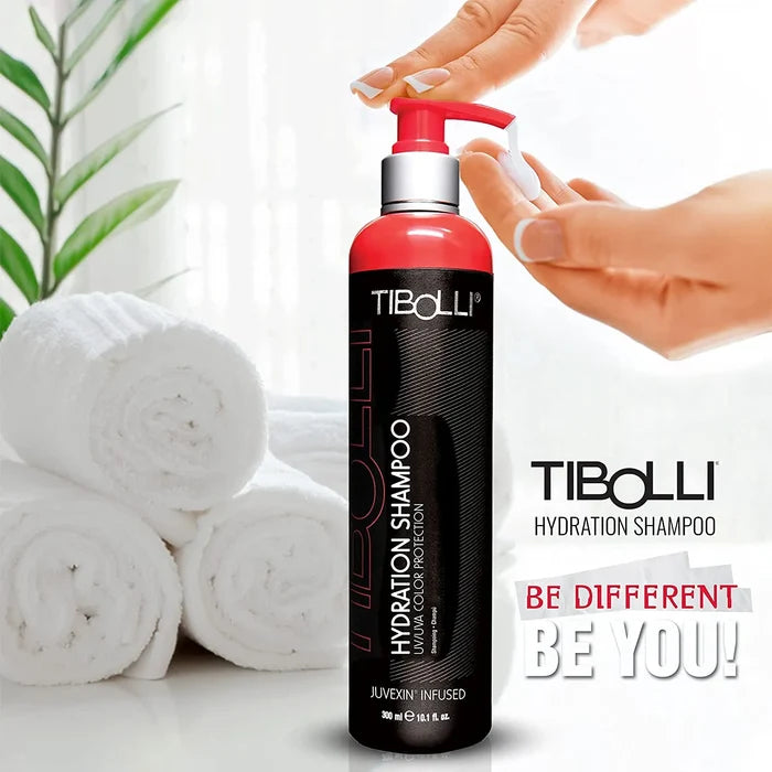 Tibolli Hydration Shampoo 300 ml black bottle with a red pump beside rolled towels; text reads "Be Different Be You!"