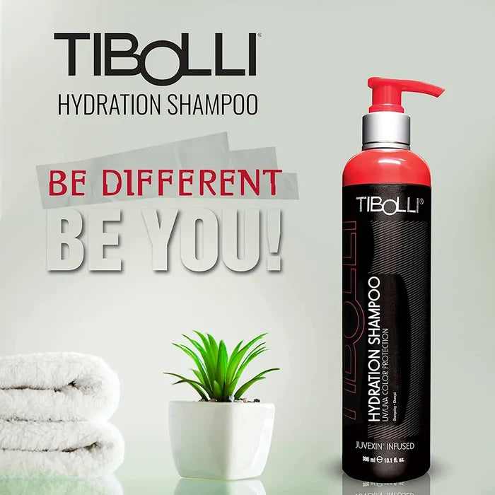 Tibolli Hydration Shampoo 300 ml bottle with red pump, white towels and a potted succulent, headline Be Different Be You