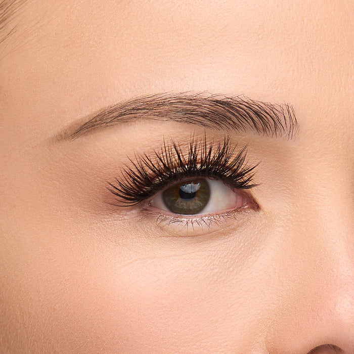 Iconic flared lash with full volume, long length, and defined spiky fibers shown on an eye.