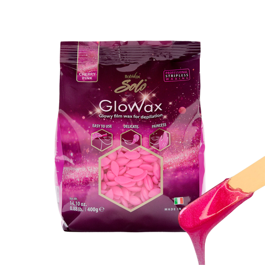 W399B Italwax 500g Cherry Pink Film Wax | Dark pink package of Italwax Solo Glowax Cherry Film wax with pink wax beads and a spatula with bright pink wax dripping on a white background