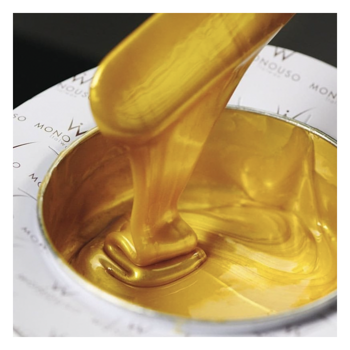 W323 Italwax Full Body Film Wax | A close-up of thick, glossy metallic gold Italwax full body film wax being scooped with a spatula from a white tin can, with the brand name partially visible on the tin.