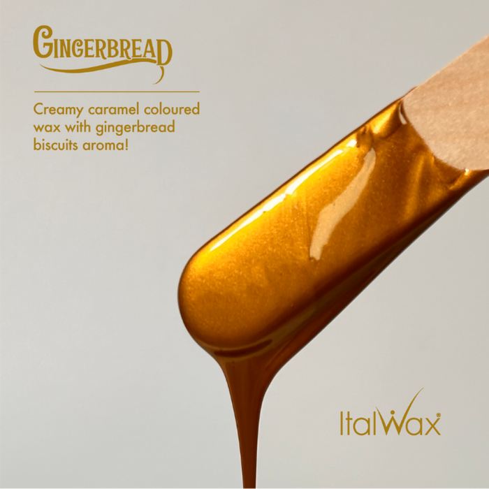 W500 Italwax 500g Candy Cane Film Wax | Gingerbread scented wax on a wooden spatula dripping with Italwax branding on a gray background