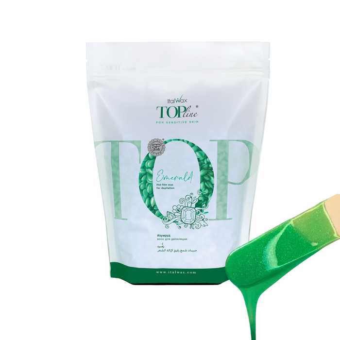 W332 Italwax 1kg Top Line Synthetic Emerald Film Wax | Green Italwax Emerald film wax, for professional hair removal, in a white and green branded Italwax plastic bag with bright green wax beads showing and a wooden spatula with shiny green wax dripping
