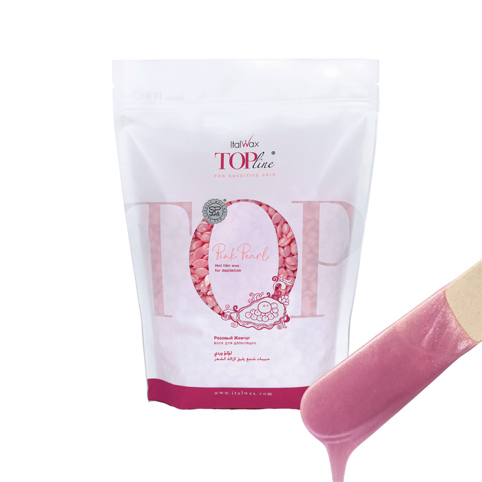 W318 Italwax 1kg Top Line Synthetic Pink Pearl Film Wax | A bag of bright yellow wax in a branded Italwax plastic bag with pink pearl wax beads showing, and in the foreground a wooden spatula with pink pearl wax dripping