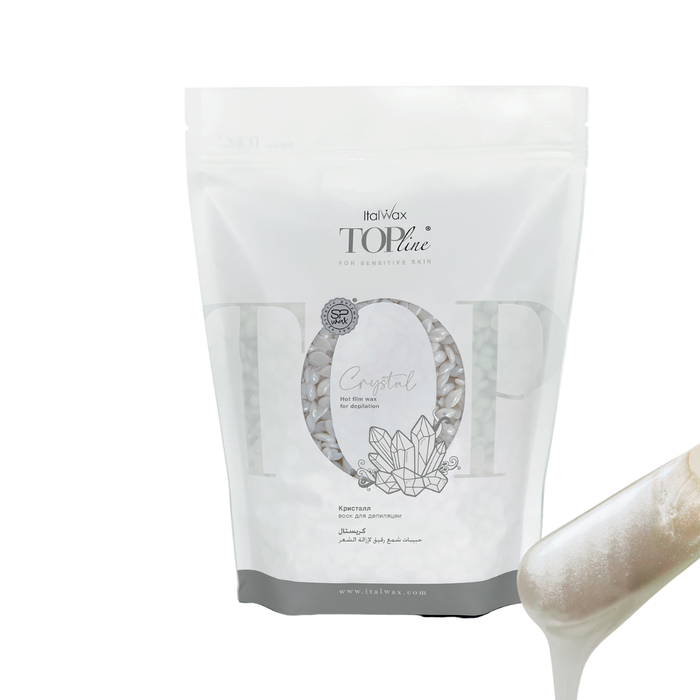 W317 Italwax Synthetic Crystal Film Wax | A bag of pearl white Italwax Crystal film wax, for professional hair removal on sensitive skin, in a white and grey branded Italwax plastic bag with a wooden spatula and pearl white wax dripping in the foreground