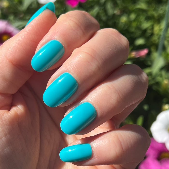 Jewel Pop | Round | Short vibrant nearly neon turquoise blue press-on nails in a short round shape for an easy mani