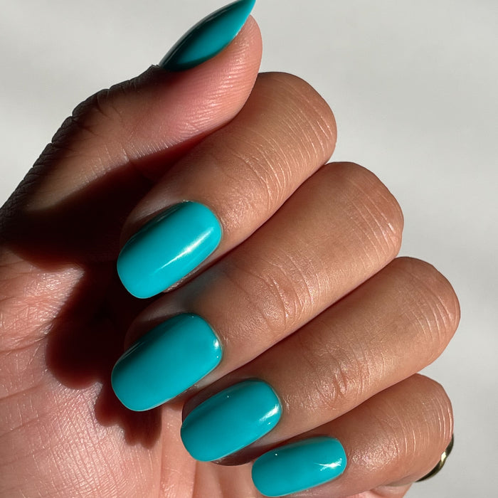 Jewel Pop | Round | Short bright nearly neon turquoise blue press-on nails in a short round shape for an easy mani