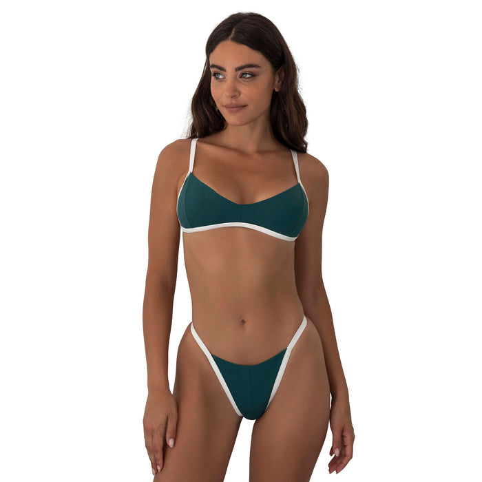 Woman wearing a teal and white bikini on a white background