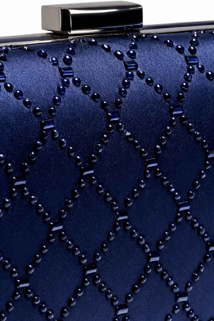 Close-up of navy blue box clutch featuring intricate bead and stud diamond design, with a silver clasp closure at the top