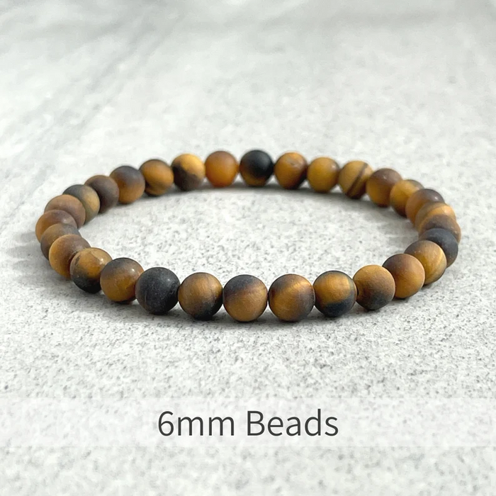 Matte Tiger Eye bead bracelet with 10mm elastic and gold-plated spacer, handcrafted.