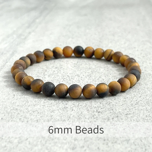 Matte Tiger Eye bead bracelet with 10mm elastic and gold-plated spacer, handcrafted.