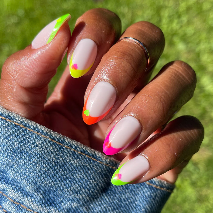 Neon Heart French | Almond | Medium press-on nails featuring neutral base with vibrant neon tips and small heart designs