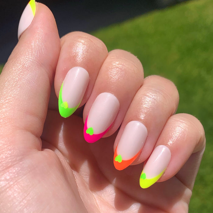 Neon Heart French | Almond | Medium press-on nails with neutral base, neon tips, and contrasting neon heart accents for a vibrant mani