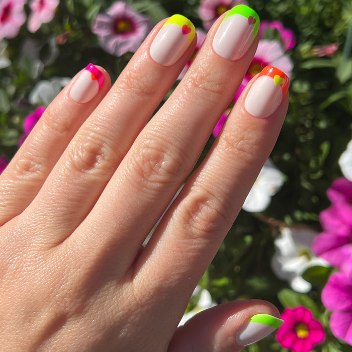 Neon Heart French | Squoval | Extra Short press-on nails with neutral base, neon tips, and bright heart accents for a fresh mani