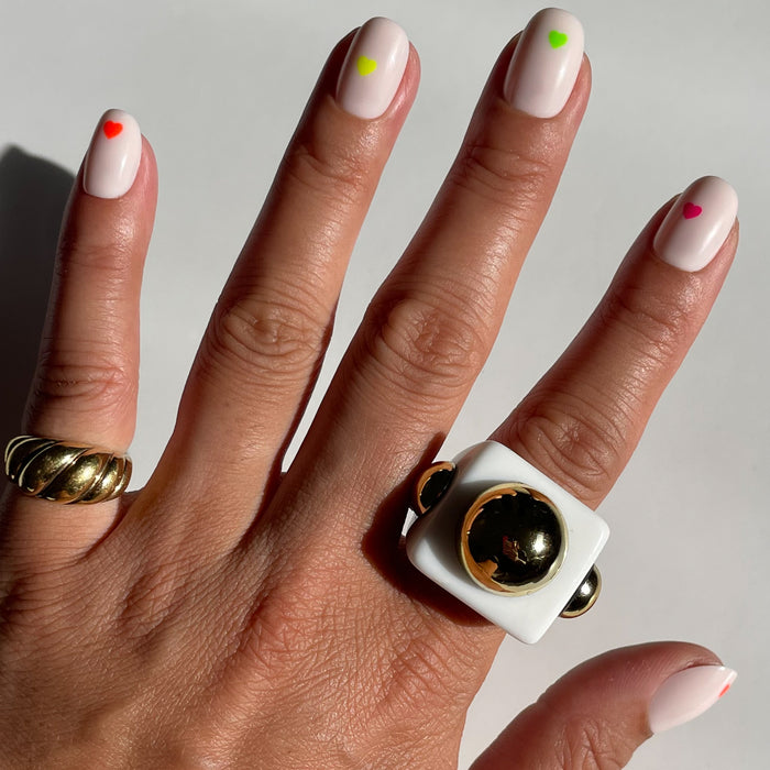 Neon Hearts | Round | Extra Short press-on nails with a neutral base and tiny colorful neon heart accents for an easy at-home mani