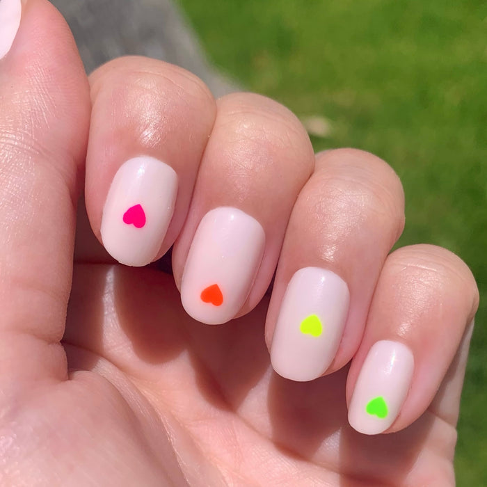 Neon Hearts | Round | Extra Short press-on nails with neutral base and colorful neon hearts for a simple at-home mani