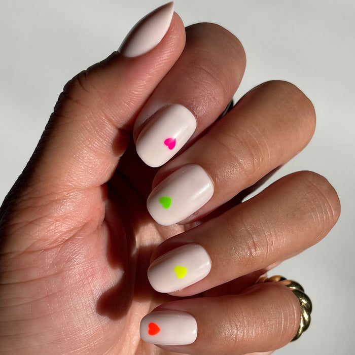 Neon Hearts | Round | Extra Short press-on nails with a neutral base and colorful small neon hearts for an easy manicure